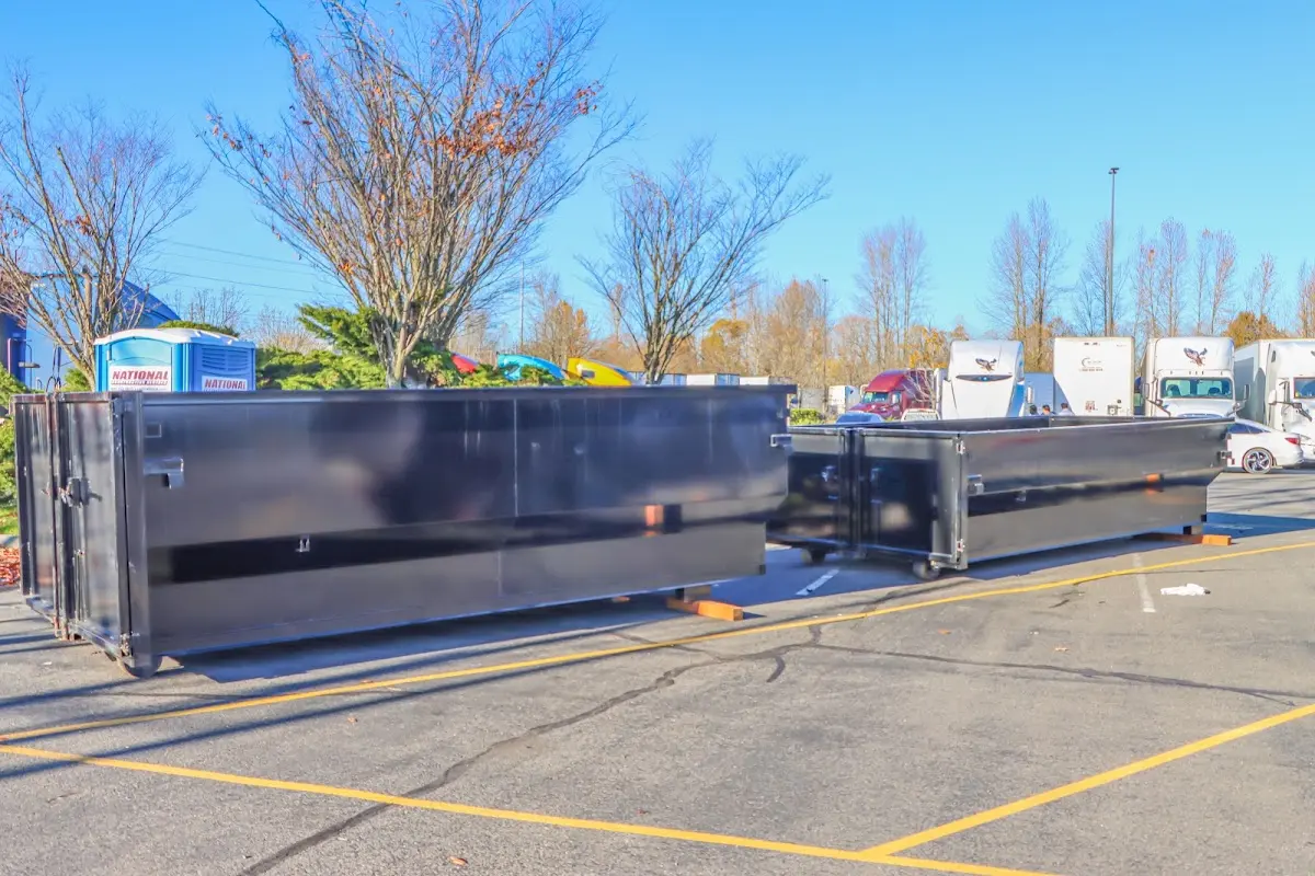 Professional dumpster rental service with roll-off container on residential driveway in Racine